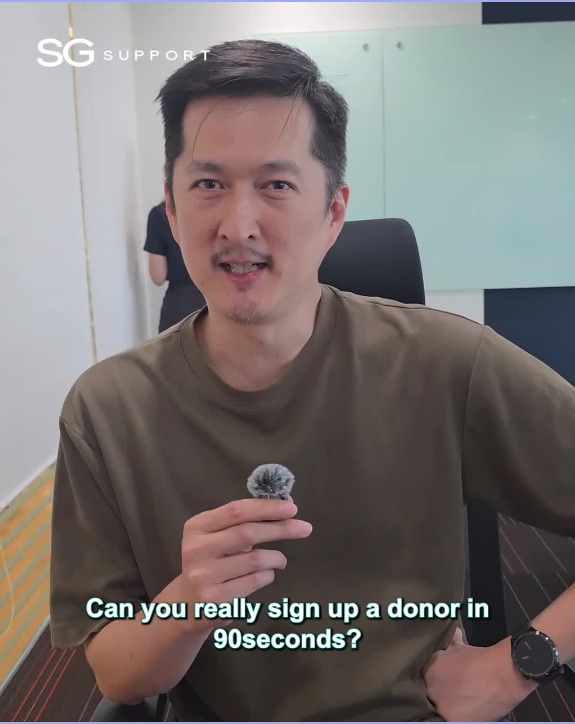 SG Support short-form video frame of a man holding a microphone with the caption Can you really sign up a donor in 90 seconds?